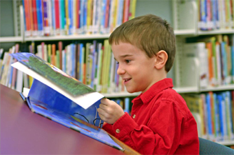 little boy reading a book