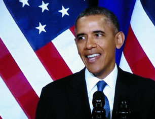 Obama smiling in front of US Flag