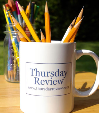 Thursday Review coffee mug with pencils in it