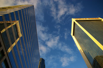 view of sky looking up through skyscrapers