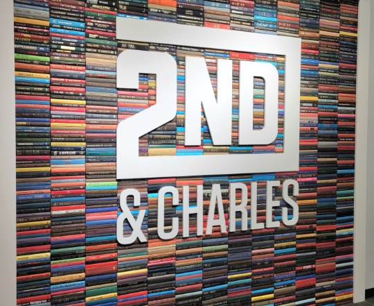 Photo of the book wall inside a 2nd & Charles store, photo by Thursday Review